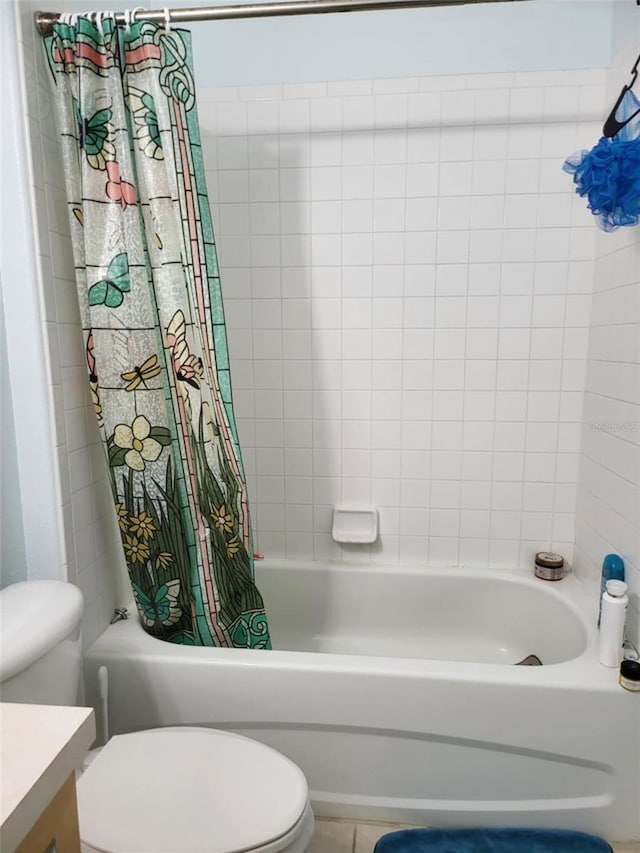 full bathroom featuring toilet, vanity, and shower / bathtub combination with curtain