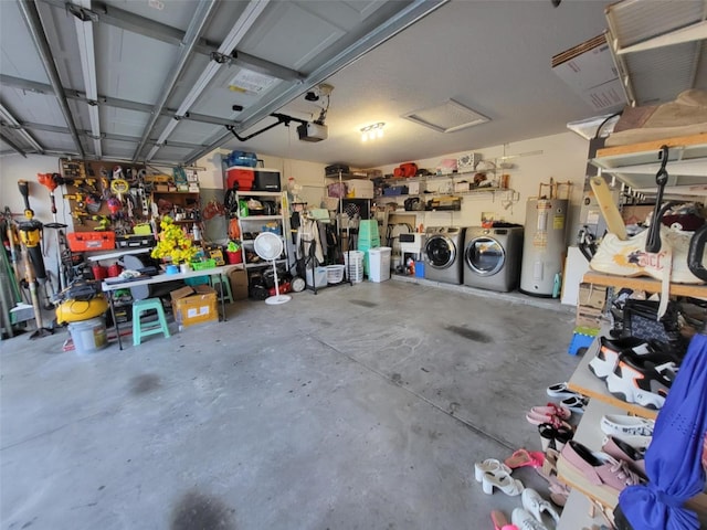 garage with a garage door opener, washer and clothes dryer, a workshop area, and electric water heater