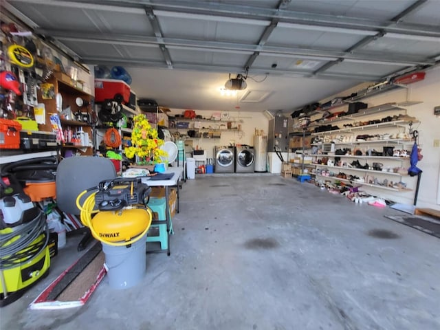 garage featuring a garage door opener, washing machine and dryer, gas water heater, and a workshop area