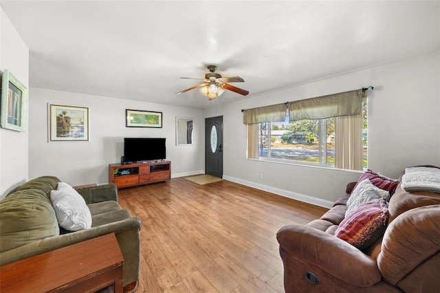 living room featuring ceiling fan and light wood-type flooring