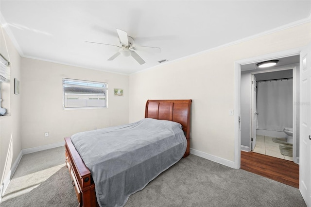 carpeted bedroom with ornamental molding and ceiling fan