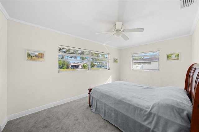 carpeted bedroom featuring crown molding and ceiling fan