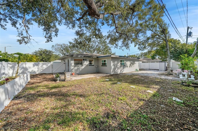 rear view of house with a yard and a patio area