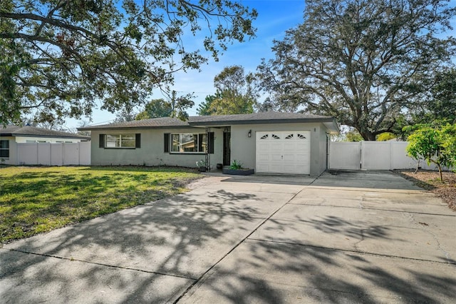 ranch-style house featuring a garage and a front yard