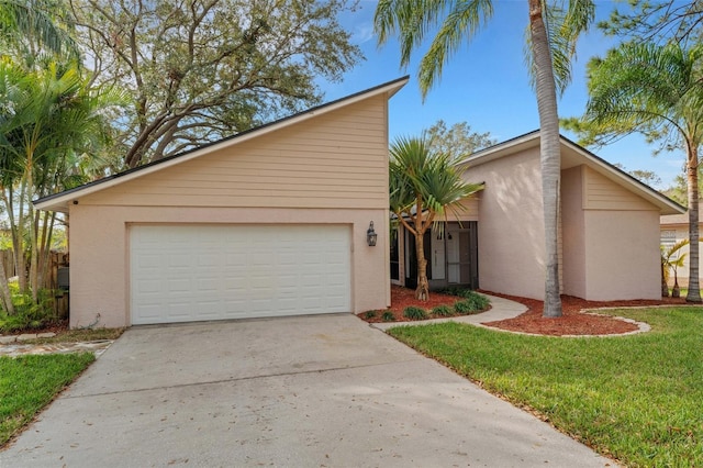 view of front of house with a garage and a front yard