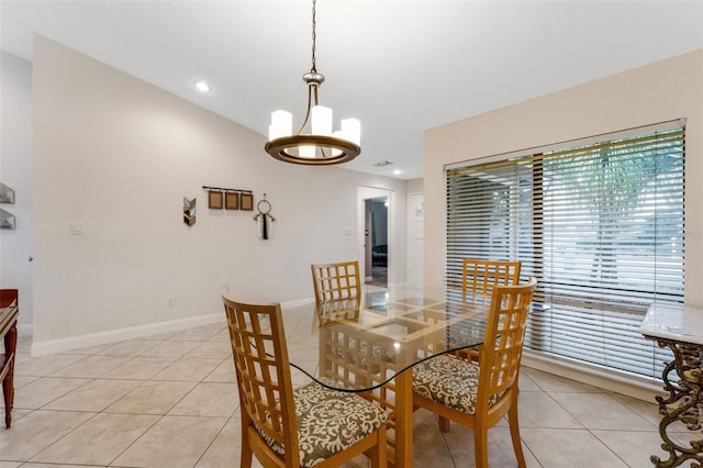 tiled dining area featuring an inviting chandelier