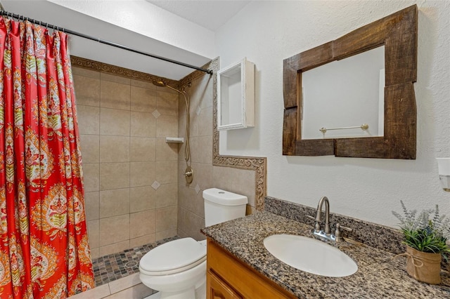 bathroom with toilet, vanity, and walk in shower