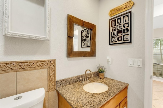 bathroom featuring vanity, toilet, and tile patterned flooring