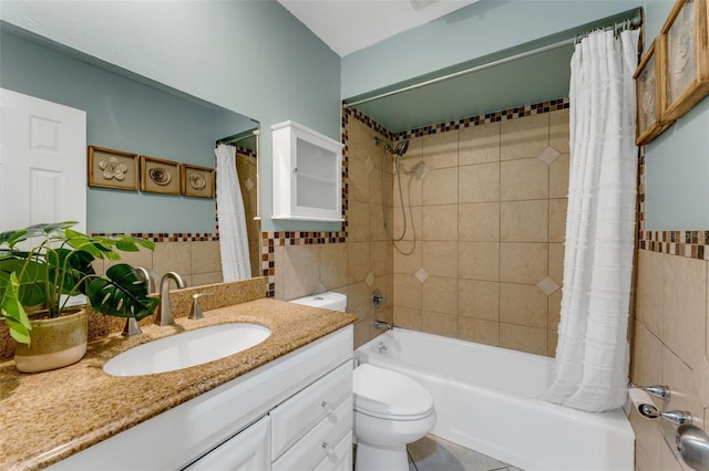 full bathroom with vanity, toilet, tile walls, and shower / bath combo with shower curtain