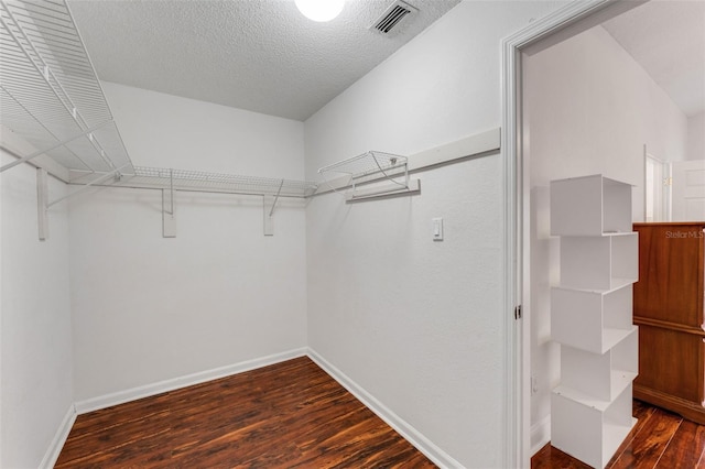 walk in closet featuring dark wood-type flooring