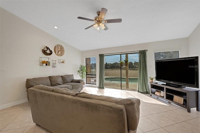 tiled living room with ceiling fan and lofted ceiling