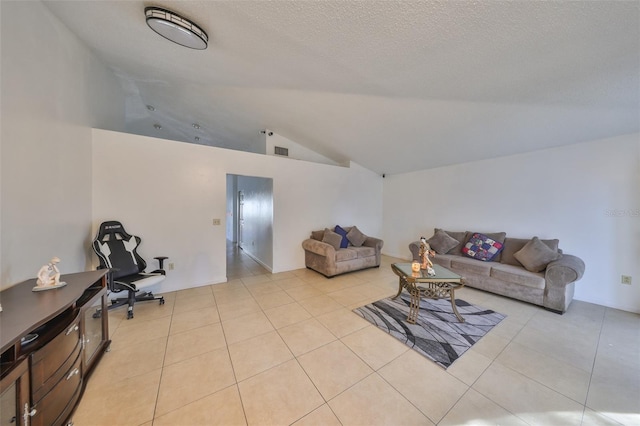 living room with vaulted ceiling, a textured ceiling, and light tile patterned floors