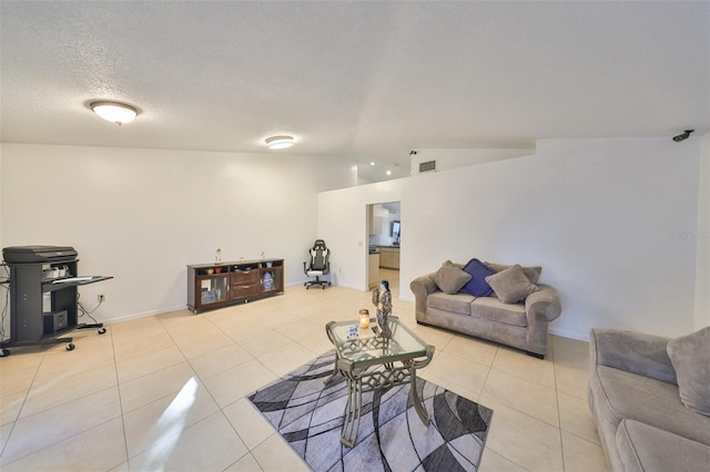 tiled living room featuring lofted ceiling and a textured ceiling