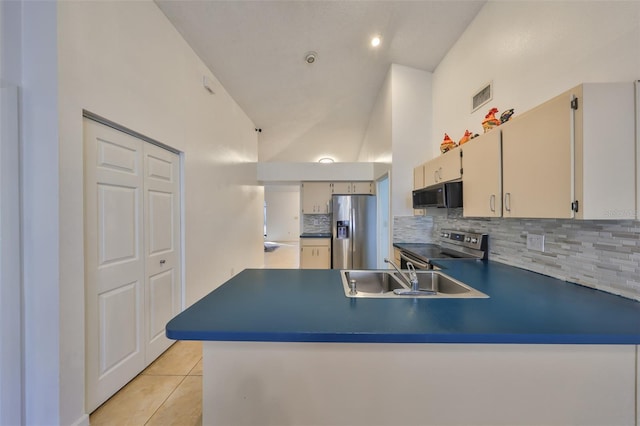 kitchen featuring sink, light tile patterned floors, appliances with stainless steel finishes, tasteful backsplash, and kitchen peninsula