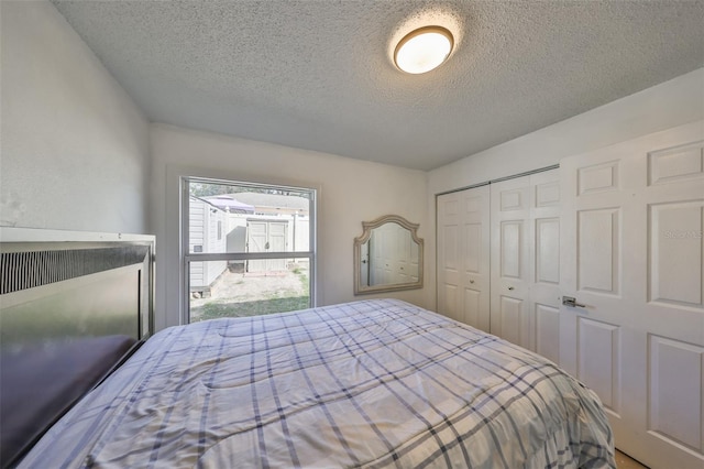 bedroom with a closet and a textured ceiling