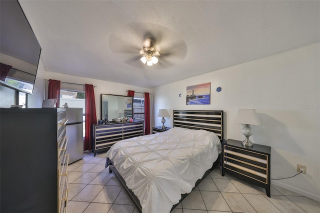 tiled bedroom with ceiling fan, stainless steel fridge, and a textured ceiling