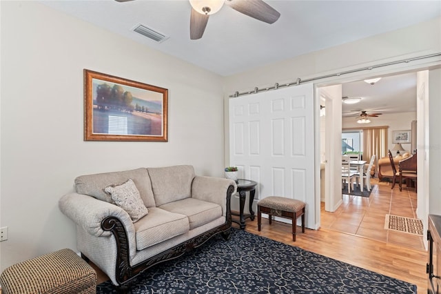 living room featuring ceiling fan and wood-type flooring