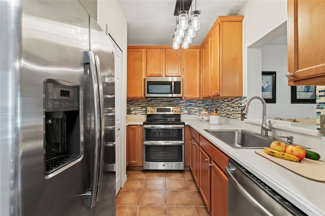 kitchen featuring sink, decorative backsplash, light tile patterned floors, and appliances with stainless steel finishes