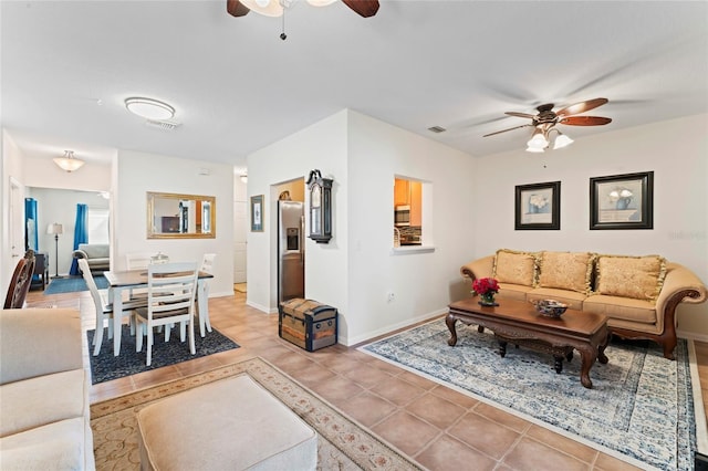 tiled living room featuring ceiling fan