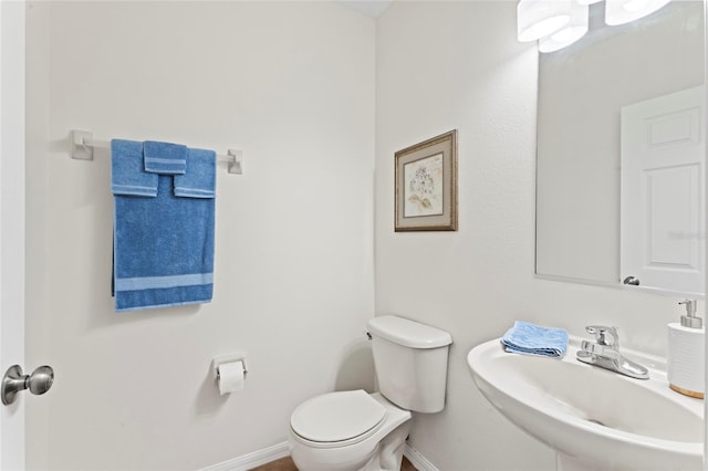 bathroom featuring toilet and sink