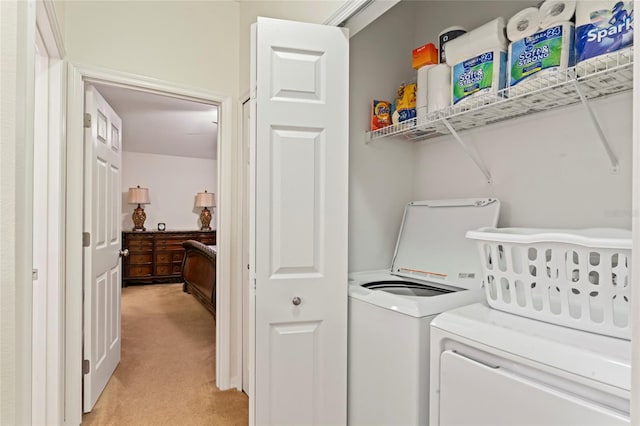 laundry room featuring light colored carpet and washing machine and clothes dryer