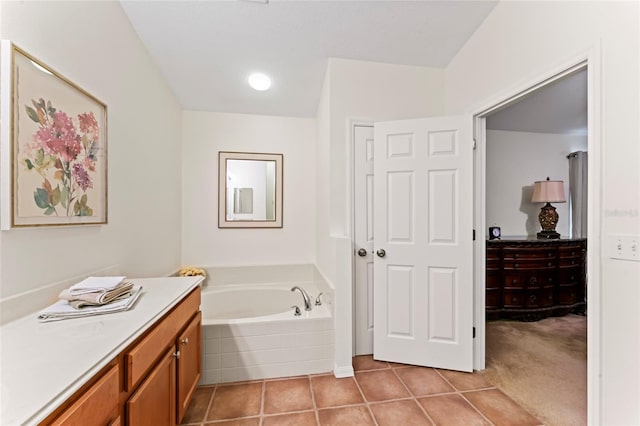 bathroom featuring tile patterned flooring, vanity, and a tub