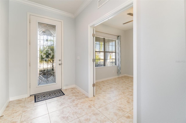 tiled entrance foyer with ornamental molding and ceiling fan