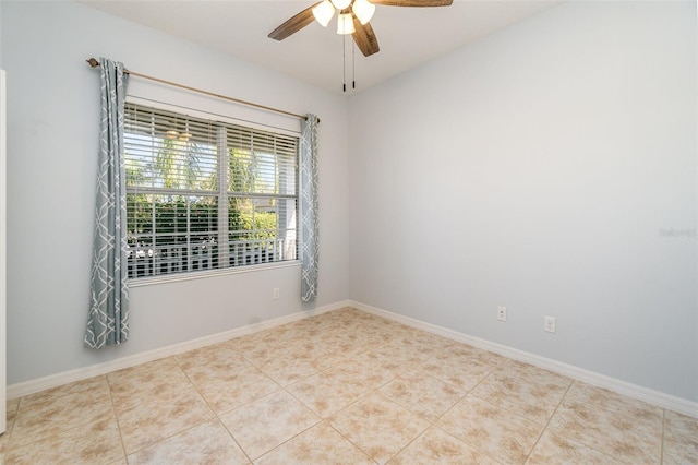 spare room with light tile patterned floors and ceiling fan