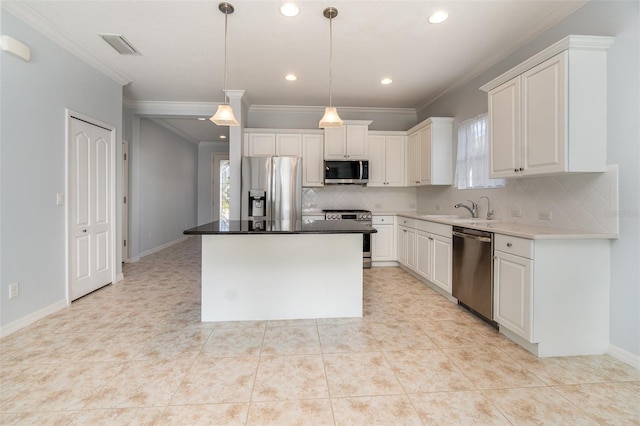 kitchen featuring stainless steel appliances, a center island, hanging light fixtures, and white cabinets