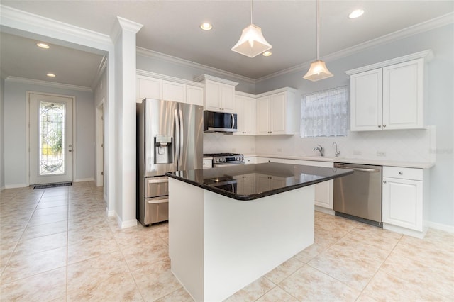 kitchen with a kitchen island, appliances with stainless steel finishes, and white cabinets