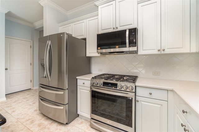 kitchen featuring appliances with stainless steel finishes, white cabinets, backsplash, light tile patterned floors, and crown molding