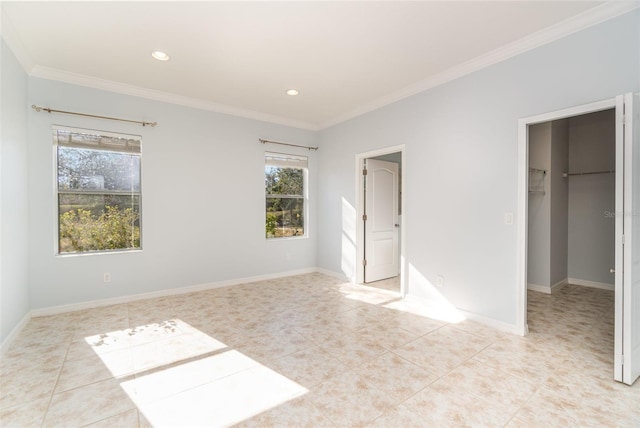 unfurnished bedroom featuring crown molding, a spacious closet, a closet, and light tile patterned flooring