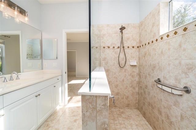 bathroom with tiled shower, vanity, tile patterned floors, and ornamental molding