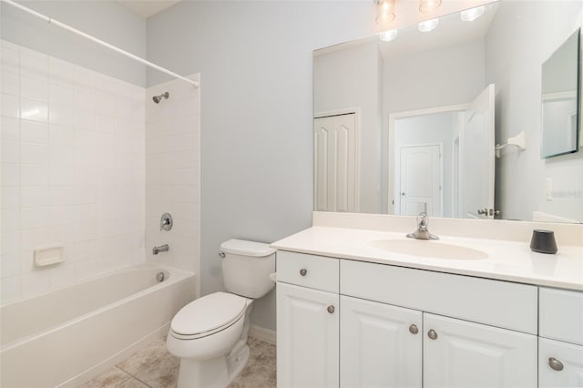 full bathroom featuring vanity, tile patterned floors, toilet, and tiled shower / bath