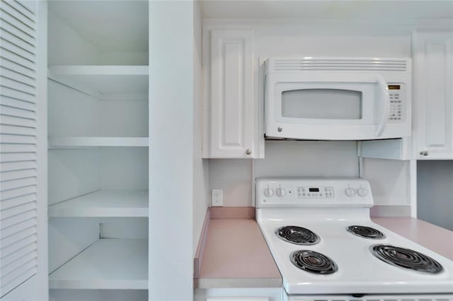 kitchen with white appliances and white cabinets