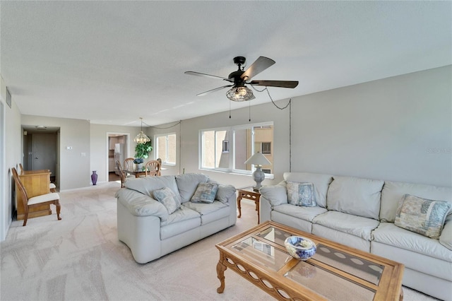 carpeted living room featuring ceiling fan and a textured ceiling