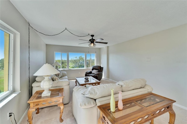 carpeted living room featuring ceiling fan