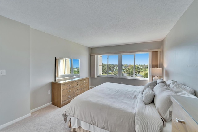 carpeted bedroom with a textured ceiling