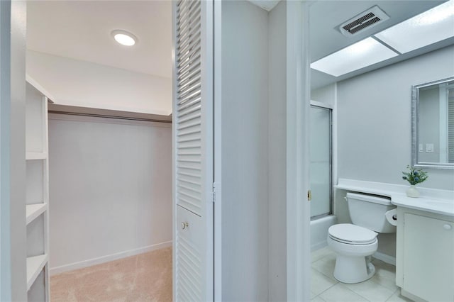 full bathroom featuring vanity, toilet, and bath / shower combo with glass door