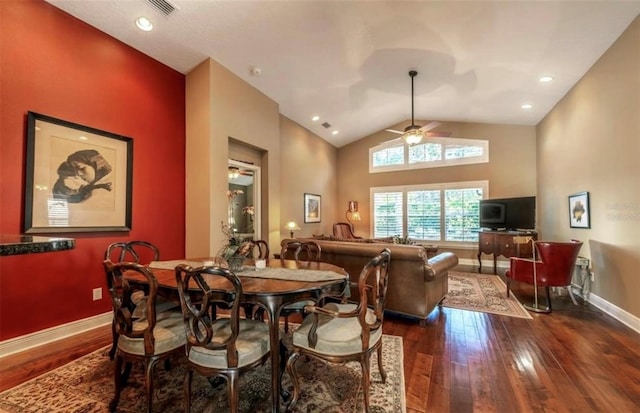 dining room featuring dark wood-type flooring, high vaulted ceiling, and ceiling fan