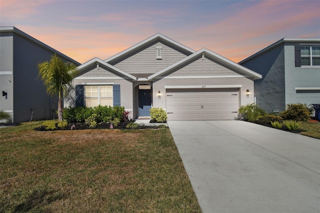 view of front of property with a yard and a garage