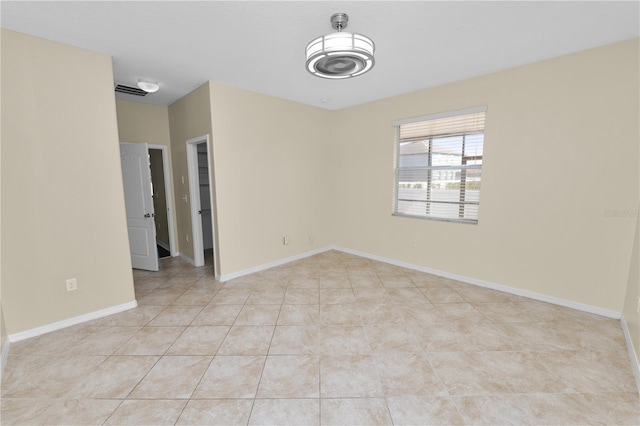 unfurnished room with light tile patterned floors