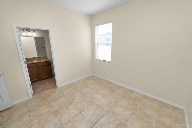 tiled spare room with sink