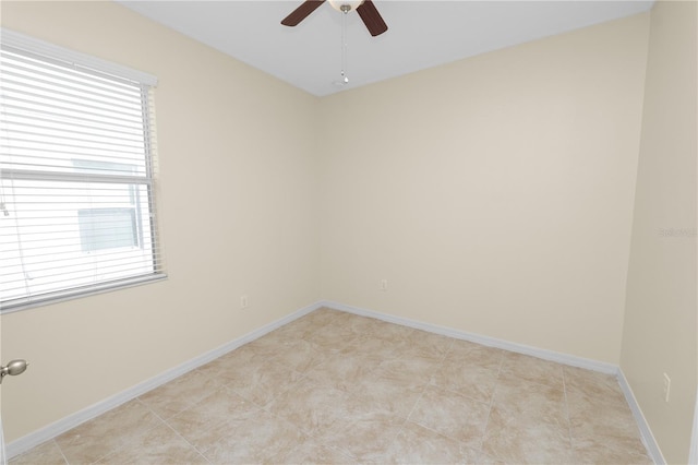 tiled empty room with ceiling fan