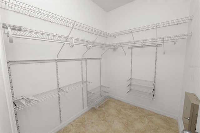 walk in closet with light tile patterned flooring