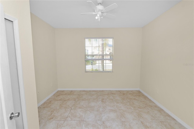 tiled spare room featuring ceiling fan