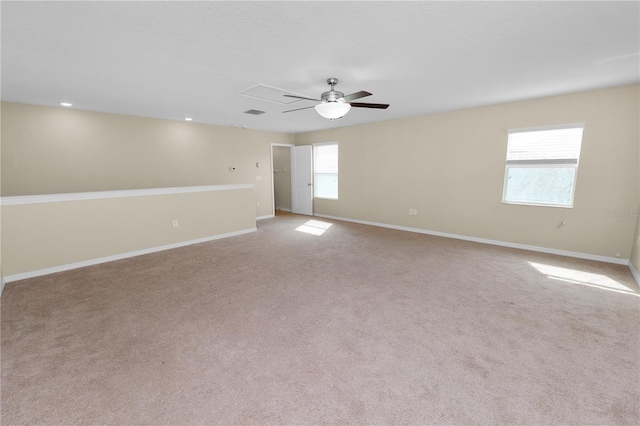 carpeted spare room with ceiling fan