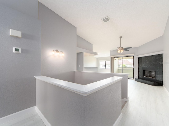 corridor featuring light hardwood / wood-style floors and vaulted ceiling