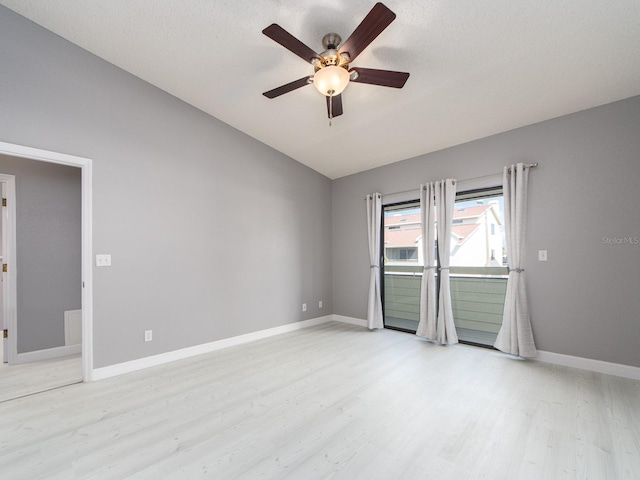 empty room featuring ceiling fan, lofted ceiling, and light hardwood / wood-style floors