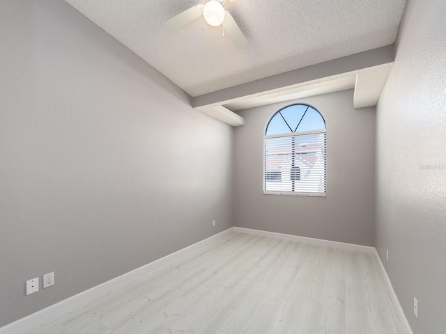 empty room featuring ceiling fan, a textured ceiling, and light wood-type flooring